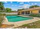 Large pool with diving board on the back of the house, surrounded by a white fence at 3942 Orange Lake Dr, Orlando, FL 32817