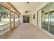Spacious screened porch with neutral tile, fan, access to yard, and natural light at 3942 Orange Lake Dr, Orlando, FL 32817