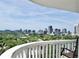Expansive city views from the balcony, showcasing the skyline and lush greenery below, with a chair at 400 E Colonial Dr # 1609, Orlando, FL 32803