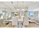 Elegant dining room featuring a modern white table, leather chairs, mirrored wall and stylish lighting at 400 E Colonial Dr # 1609, Orlando, FL 32803