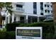 Elegant condominium building featuring a sign, lush landscaping and visitor parking access at 400 E Colonial Dr # 1609, Orlando, FL 32803