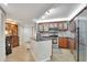 Well-appointed kitchen with stainless steel appliances, granite countertops, and wood cabinets providing ample storage at 400 E Colonial Dr # 1609, Orlando, FL 32803