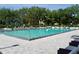Large community swimming pool with ample lounge chairs and lush greenery surrounding the area at 400 E Colonial Dr # 1609, Orlando, FL 32803
