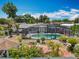 Aerial view of backyard pool and outdoor living space featuring mature trees in a residential neighborhood at 4021 Queen Anne Dr, Orlando, FL 32839