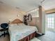 A bedroom featuring a patterned bedspread, accent wall and door with a glass block window above it at 4021 Queen Anne Dr, Orlando, FL 32839