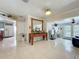 Inviting foyer and open living room with large tile floors, and a view into the kitchen at 4021 Queen Anne Dr, Orlando, FL 32839