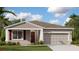 Beautiful single-story home with neutral paint, shutters, a nicely landscaped yard, and a two-car garage at 4317 Riverbend Blvd, Haines City, FL 33844