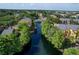 The community complex features water access, mature trees, manicured lawns, and well-maintained apartment buildings at 4528 Commander Dr # 2033, Orlando, FL 32822