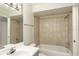 Cozy bathroom with tiled shower and tub, vanity, and bright lighting at 4528 Commander Dr # 2033, Orlando, FL 32822