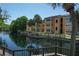 Complex exterior features balconies, canal access, and mature palms at 4528 Commander Dr # 2033, Orlando, FL 32822