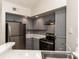 Modern kitchen features stainless steel appliances, ample cabinetry, and stylish finishes at 4528 Commander Dr # 2033, Orlando, FL 32822