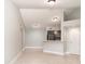 Cozy living area featuring neutral walls, tile floors, and an inviting kitchen bar at 4528 Commander Dr # 2033, Orlando, FL 32822