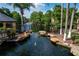 The complex features a beautiful pond with a fountain, a rock border, a metal fence, and mature palms at 4528 Commander Dr # 2033, Orlando, FL 32822