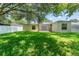 Large, well-maintained backyard with lush green grass, mature shade trees, and screened in porch at 476 Basking Ridge Ct, Ocoee, FL 34761
