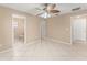 Open bedroom with neutral walls, tiled floors, with view of bathroom and closet at 476 Basking Ridge Ct, Ocoee, FL 34761