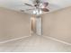 Bedroom showcasing a ceiling fan, a tiled floor, with a view to the hallway and bathroom at 476 Basking Ridge Ct, Ocoee, FL 34761