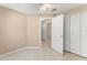 Bedroom features closet, ceiling fan, tile flooring, neutral paint and views into the hall at 476 Basking Ridge Ct, Ocoee, FL 34761