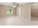Spacious bedroom featuring a ceiling fan, a window with a view, and tile flooring throughout at 476 Basking Ridge Ct, Ocoee, FL 34761