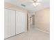 Bedroom featuring tile flooring, neutral paint and a view into the hall at 476 Basking Ridge Ct, Ocoee, FL 34761