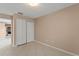 Neutral bedroom features a closet, tile floor, a light neutral paint color and an adjacent doorway at 476 Basking Ridge Ct, Ocoee, FL 34761