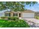 Charming single-story home with manicured lawn, brick driveway, and attached two-car garage at 476 Basking Ridge Ct, Ocoee, FL 34761