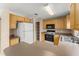 Functional kitchen featuring wood cabinets, tile floors, and a practical breakfast bar area at 476 Basking Ridge Ct, Ocoee, FL 34761