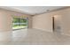 Bright living room featuring neutral walls, tile floors, and a sliding glass door to the backyard at 476 Basking Ridge Ct, Ocoee, FL 34761