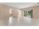 Bright, spacious living room with neutral walls and large, light-colored tile flooring throughout at 476 Basking Ridge Ct, Ocoee, FL 34761
