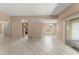 Open-concept living space with neutral walls, tile flooring, and seamless flow into dining and kitchen areas at 476 Basking Ridge Ct, Ocoee, FL 34761