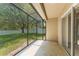 Screened patio with ample space and a view of the backyard with a white picket fence at 476 Basking Ridge Ct, Ocoee, FL 34761