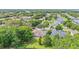 Aerial view of home in a lush community surrounded by mature trees and greenery at 4905 Emilee Grace Ln, St Cloud, FL 34771
