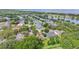 Aerial view of a neighborhood showcasing homes near a lake and natural surroundings at 4905 Emilee Grace Ln, St Cloud, FL 34771
