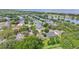 Aerial view of a neighborhood showcasing homes near a lake and natural surroundings at 4905 Emilee Grace Ln, St Cloud, FL 34771