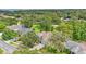Aerial view of a landscaped home surrounded by mature trees and lush greenery at 4905 Emilee Grace Ln, St Cloud, FL 34771