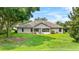 Spacious backyard featuring a well-maintained lawn, patio, and the rear exterior of the home at 4905 Emilee Grace Ln, St Cloud, FL 34771