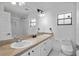 Clean bathroom featuring a double vanity, a large mirror, and a tiled shower at 4905 Emilee Grace Ln, St Cloud, FL 34771