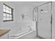 Bathroom featuring a soaking tub with tile surround and a glass-enclosed shower at 4905 Emilee Grace Ln, St Cloud, FL 34771