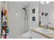 Bright bathroom featuring a shower with black hardware, white vanity and ceramic tile floors at 4905 Emilee Grace Ln, St Cloud, FL 34771