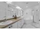 Large bathroom with double sink vanity, a soaking tub, and a glass enclosed shower at 4905 Emilee Grace Ln, St Cloud, FL 34771
