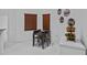Bright dining area featuring a dark table with seating for four under wood blinds at 4905 Emilee Grace Ln, St Cloud, FL 34771