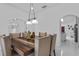 Dining room has an area that leads to the kitchen with tile floors and a wooden table and chairs at 4905 Emilee Grace Ln, St Cloud, FL 34771