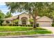 Charming home featuring a well-manicured lawn, mature trees, and attractive landscaping at 4905 Emilee Grace Ln, St Cloud, FL 34771