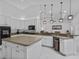 Kitchen features white cabinets, stainless steel appliances, and an island with bar seating at 4905 Emilee Grace Ln, St Cloud, FL 34771