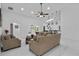 Spacious living room with a ceiling fan, bar seating, neutral-toned furniture, and great lighting at 4905 Emilee Grace Ln, St Cloud, FL 34771