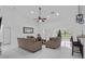 Bright living room with vaulted ceilings, sleek flooring, ceiling fan, neutral tones, and ample seating at 4905 Emilee Grace Ln, St Cloud, FL 34771