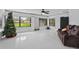 Open floor plan living room with large windows for natural light and a ceiling fan at 4905 Emilee Grace Ln, St Cloud, FL 34771