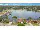 Aerial view of a neighborhood showcasing a large lake surrounded by residential properties and lush greenery at 529 Quail Down Dr, Debary, FL 32713