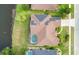 Overhead view of a home with a solar panel system and a screened-in pool within a lush green landscape at 529 Quail Down Dr, Debary, FL 32713