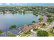 Aerial view showcasing residential properties near a serene lake, surrounded by mature trees and lush landscapes at 529 Quail Down Dr, Debary, FL 32713