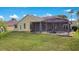 Spacious backyard featuring a screened-in pool enclosure, green lawn, and providing a private outdoor retreat at 529 Quail Down Dr, Debary, FL 32713